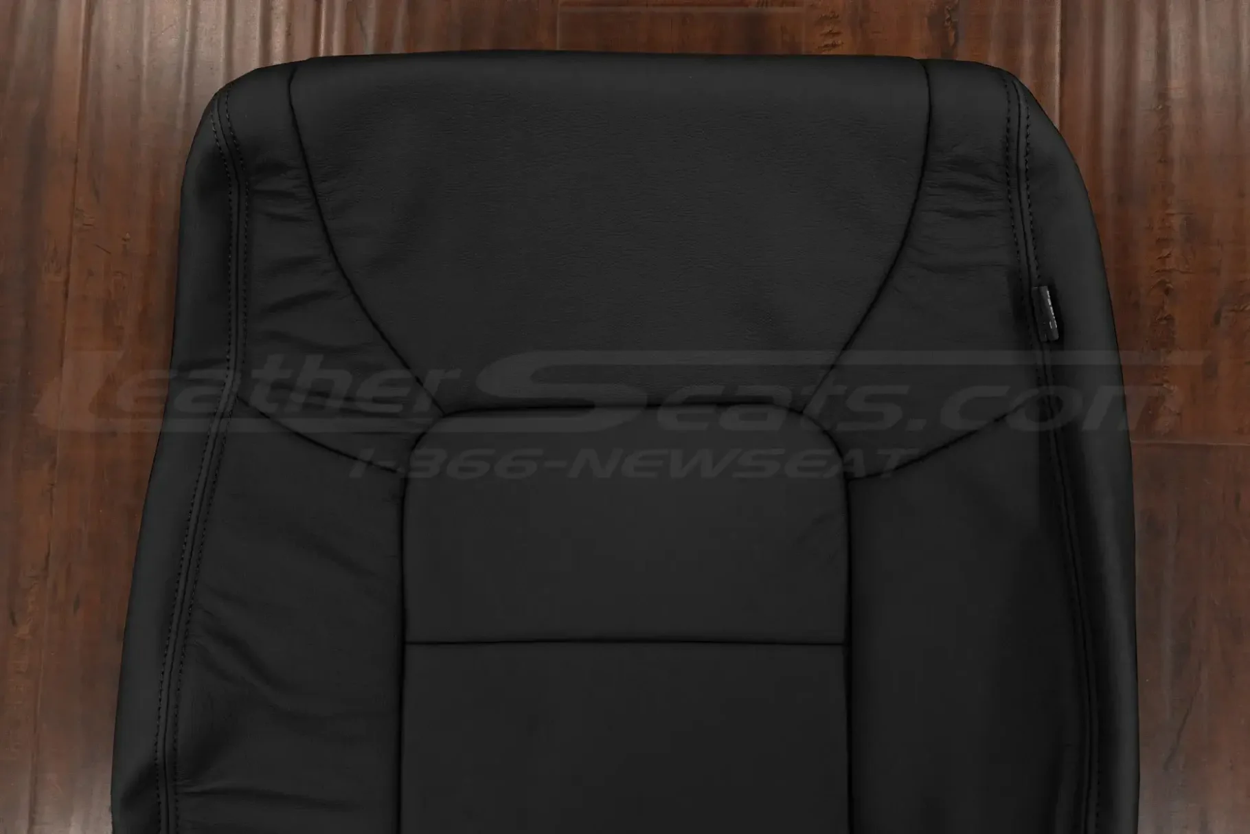 Upper section of black backrest upholstery