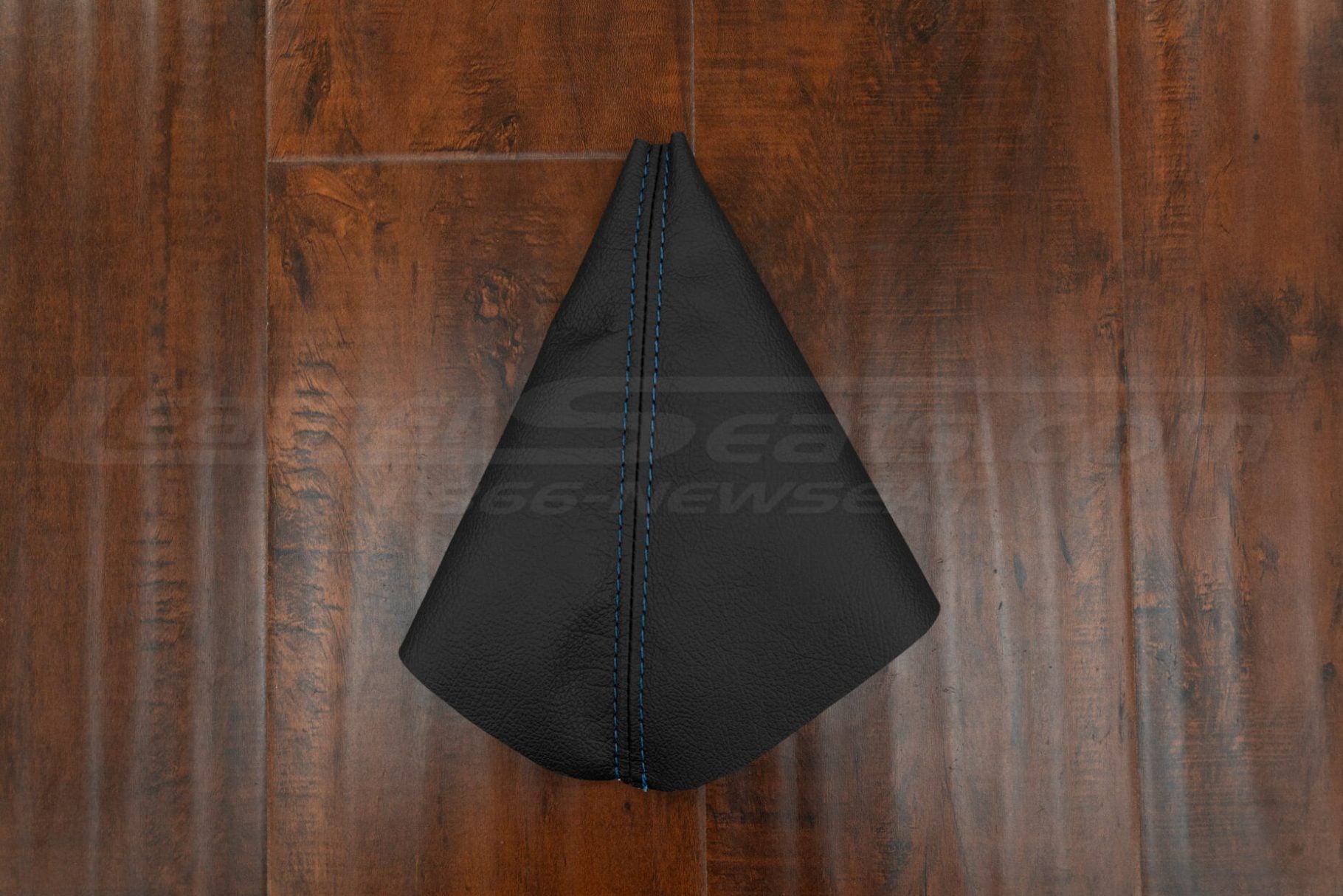 Flat lay of leather e brake boot upholstery in Black leather with blue stitching