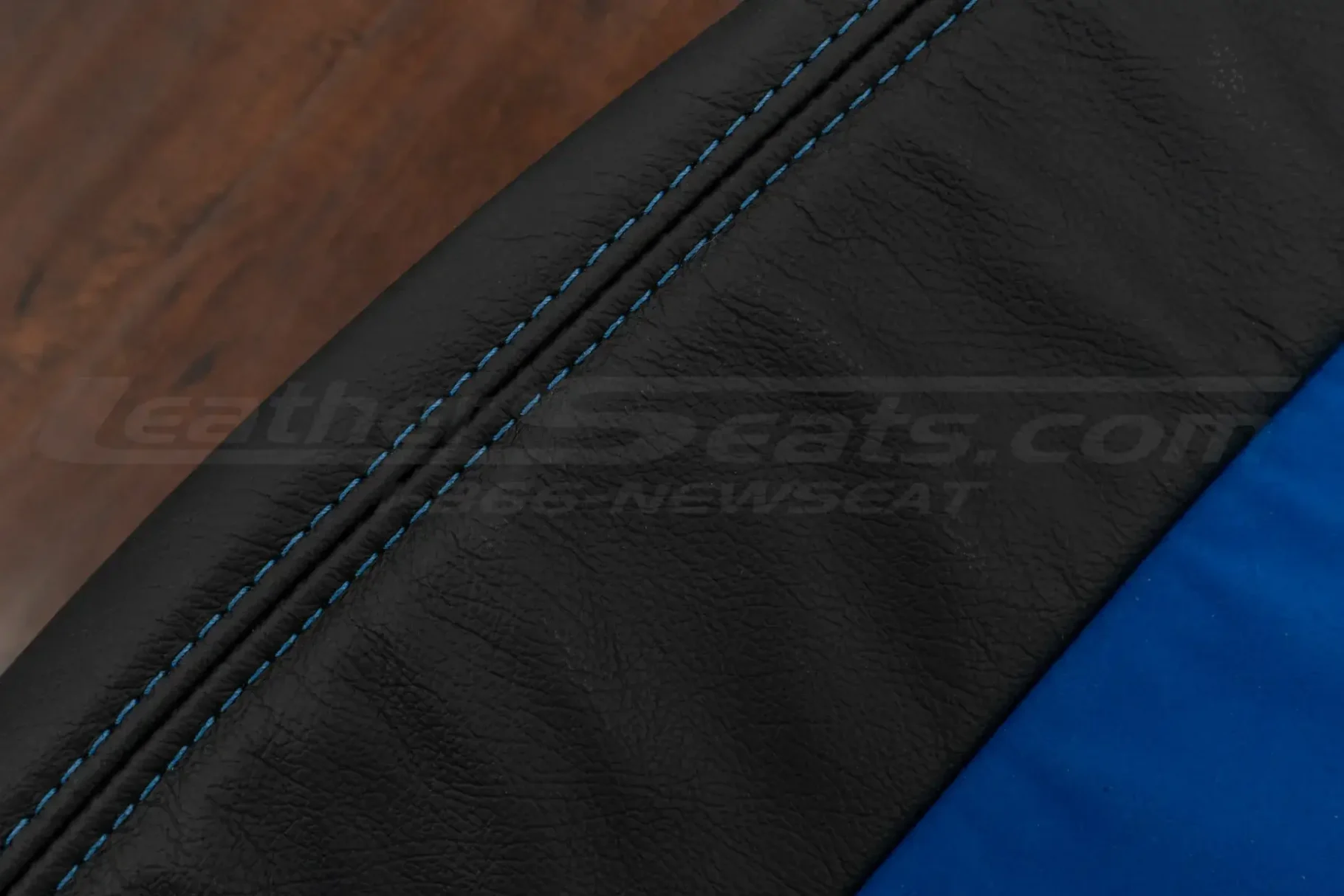 Contrast cobalt blue stitching on black leather