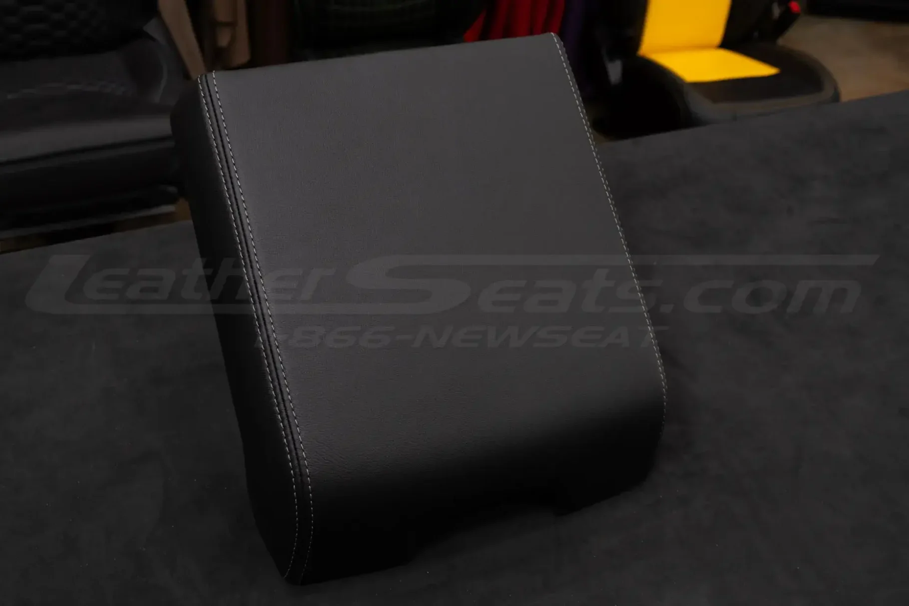 Aftermarket Ford F-150 leather console lid cover in black with contrast stitching