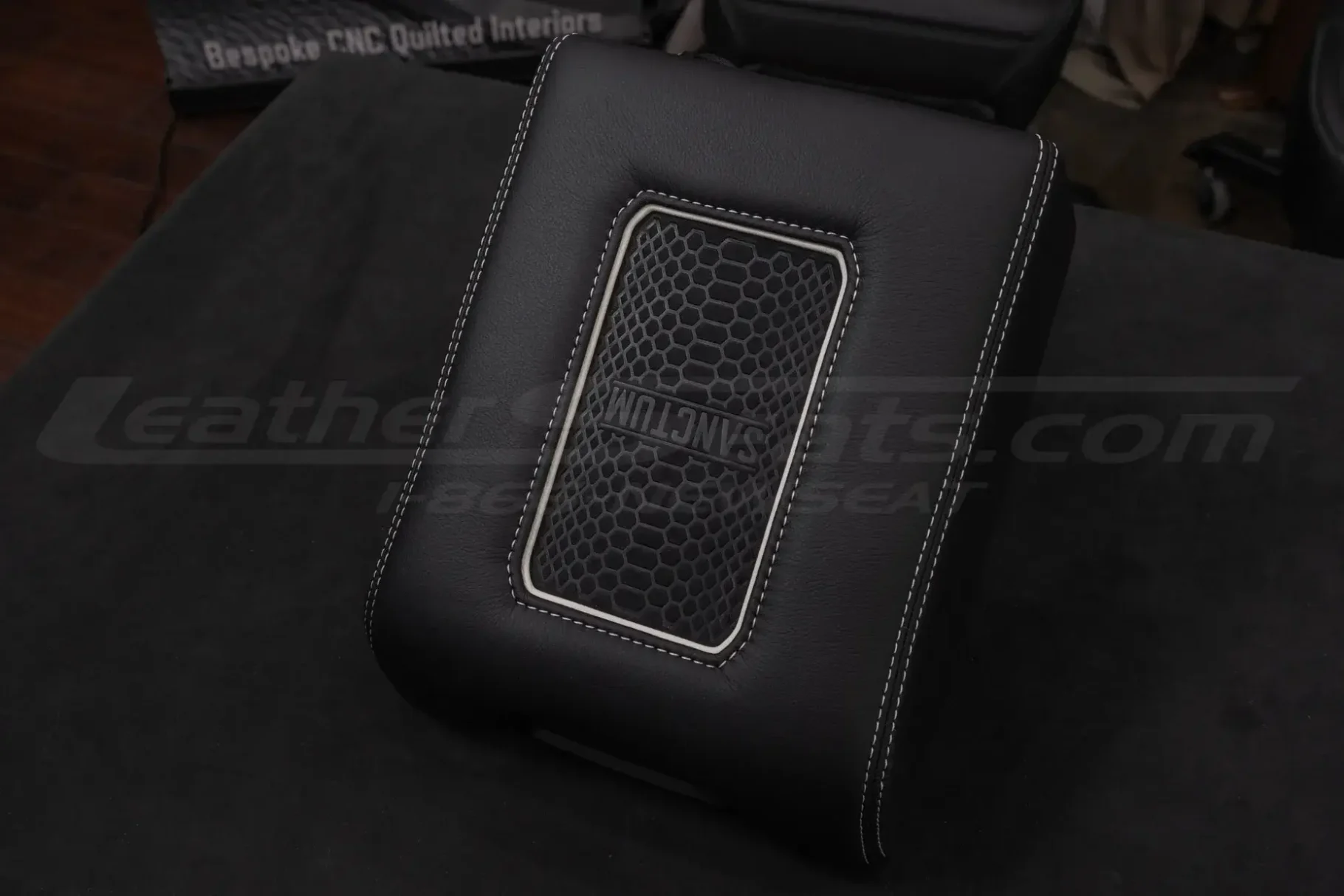 Aftermarket leaether console lid cover in black leather with white trim ring and white stitching