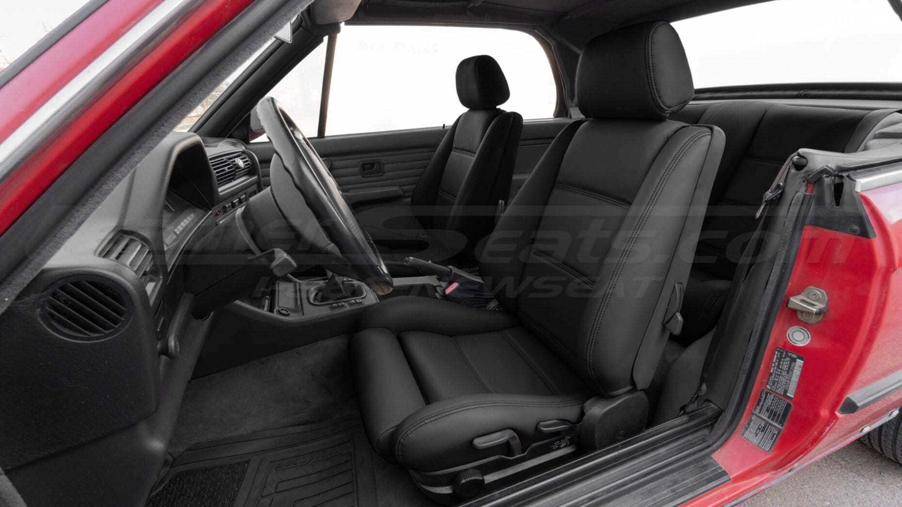 Aftermarket black replacement leather seat covers for BMW e30 - front seat installed