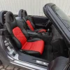 Passenger side view of black and bright red leather seats for honda s2000