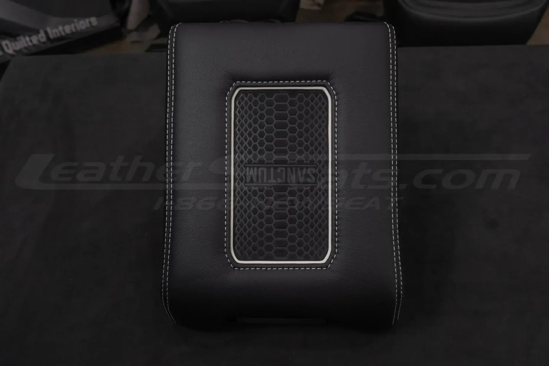 Flat view of custom leather center console lid with wireless charging