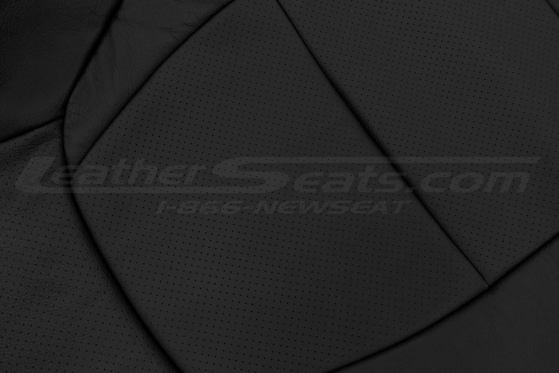 Black perforated leather backrest close-up