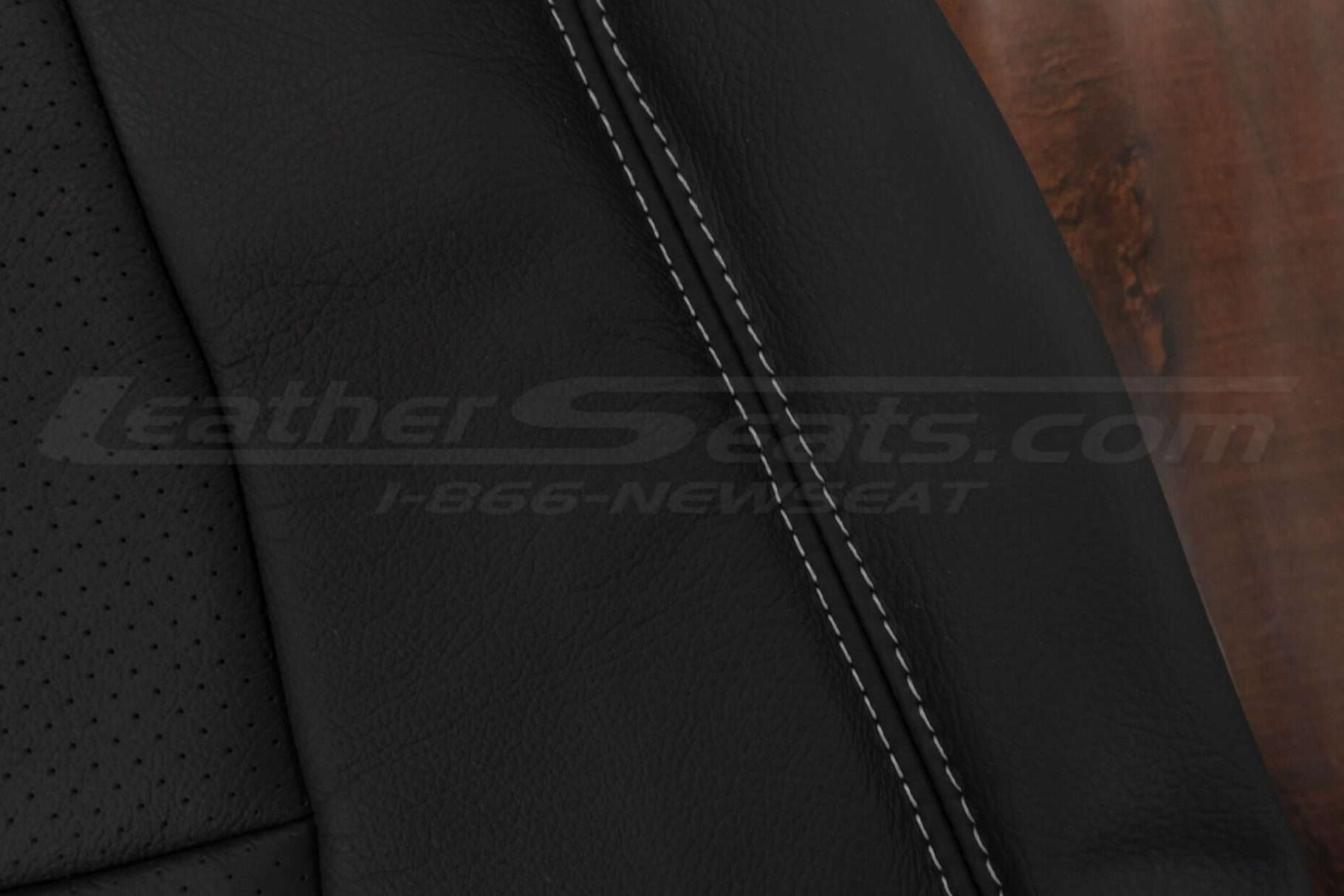 Grey double-stitching on black leather