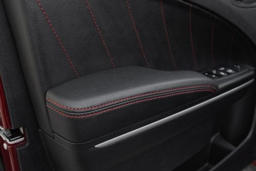 2015-2023 Dodge Charger leather door armrest upholstery installed in Black leather with Red stitching