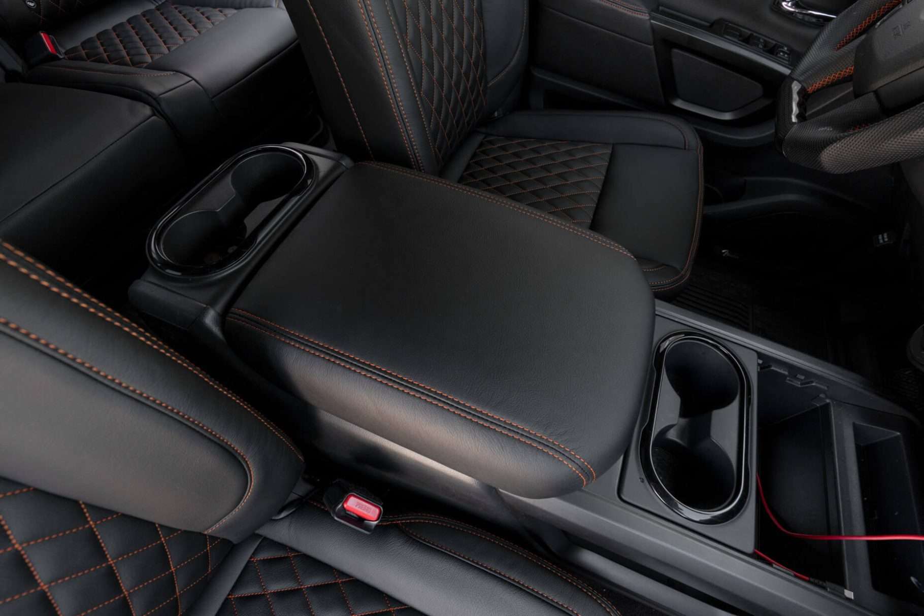 2016-2024 Nissan Titan leather console lid cver in Black with orange stitching