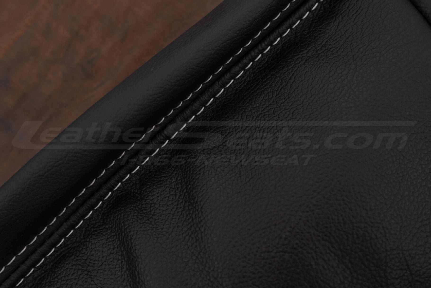 Contrasting white double-stitching on Black leather