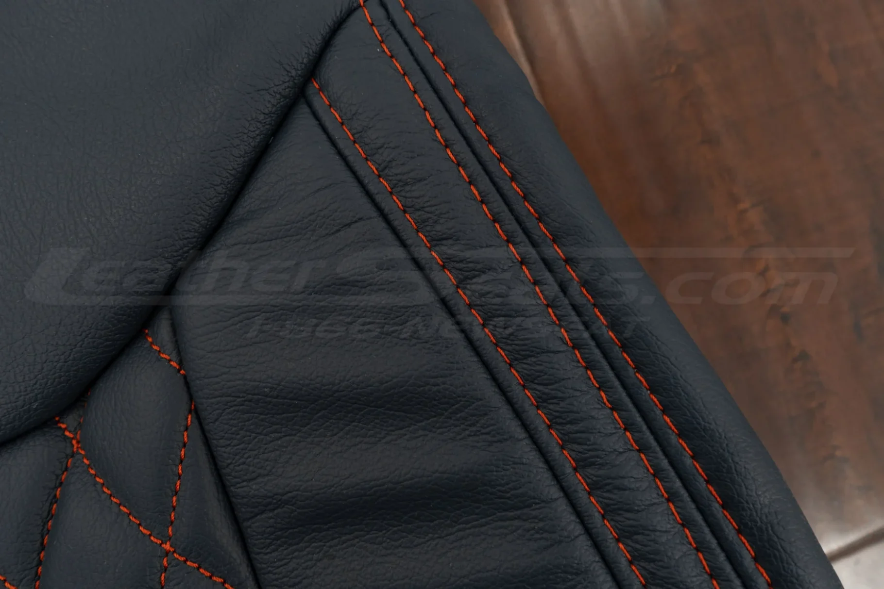 Contrastng Tangerine double-stitching on blue leather