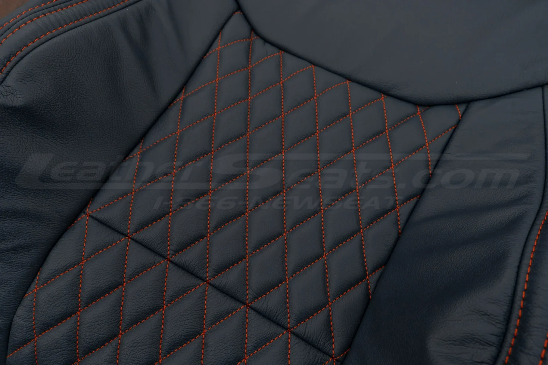 Close up of Tangerine Diamond stitching on Blue leather