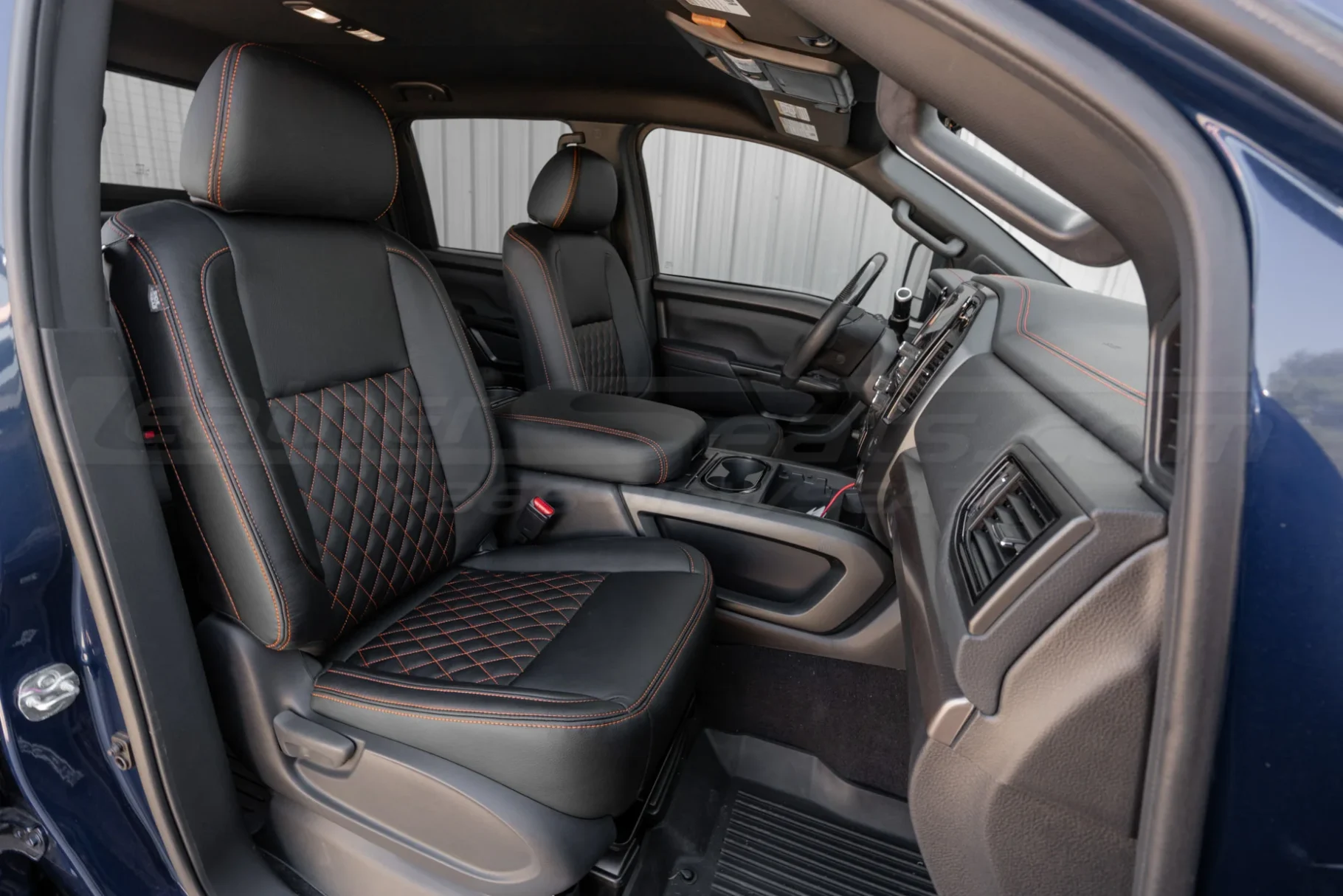Passenger side view of installed diamond stitched leather seats for Nissan Titan