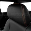Nissan Titan black leather headrest with orange stitching close-up