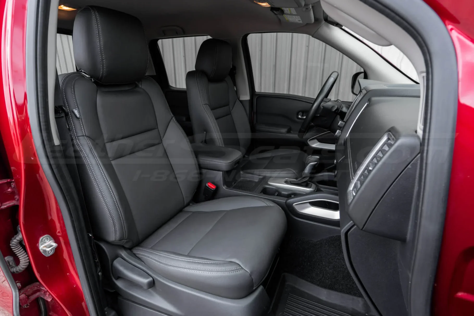 Passenger side custom replacement leather seat covers installed in Nissan Frontier