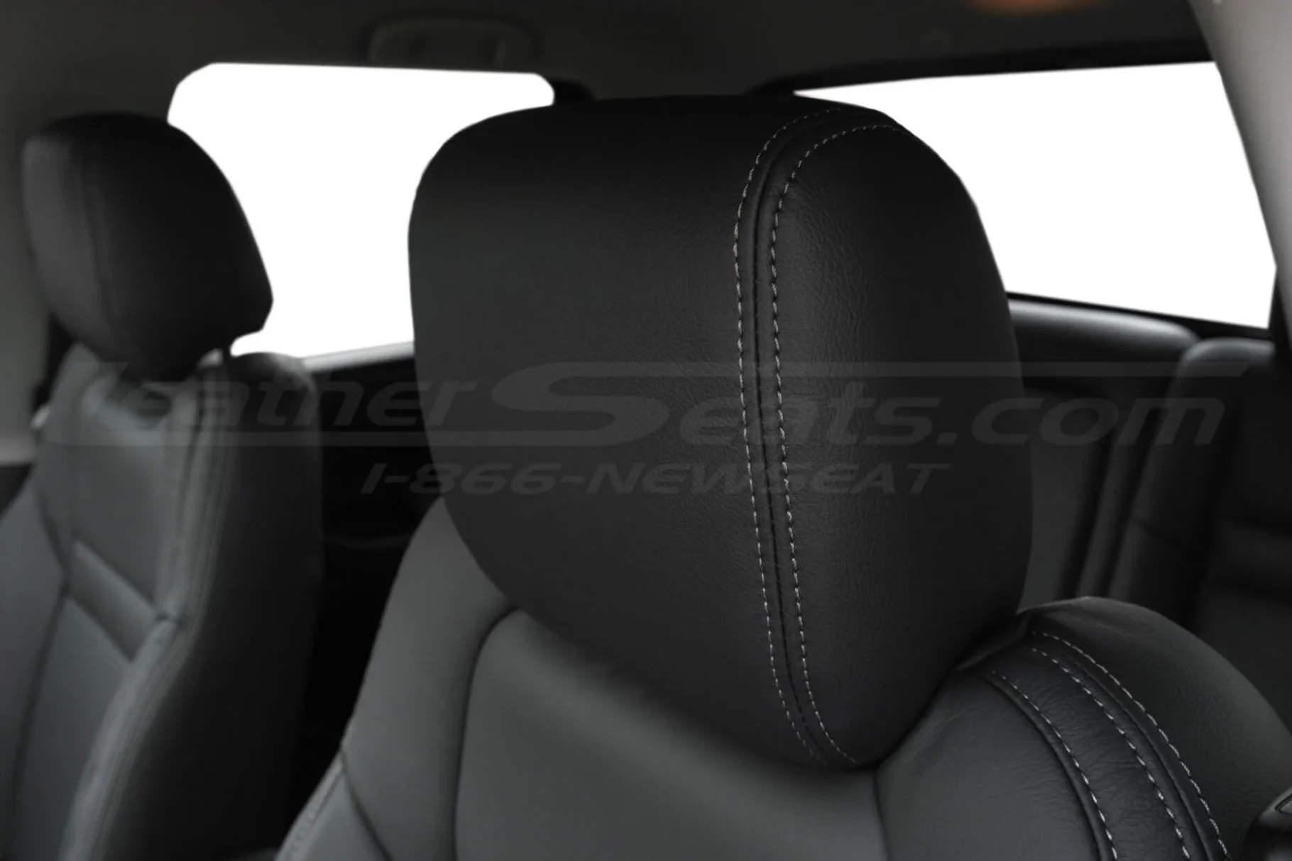 Dark Graphite leather headrest close-up with stone stitching